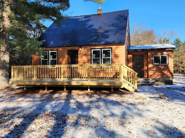 snow covered house featuring a deck