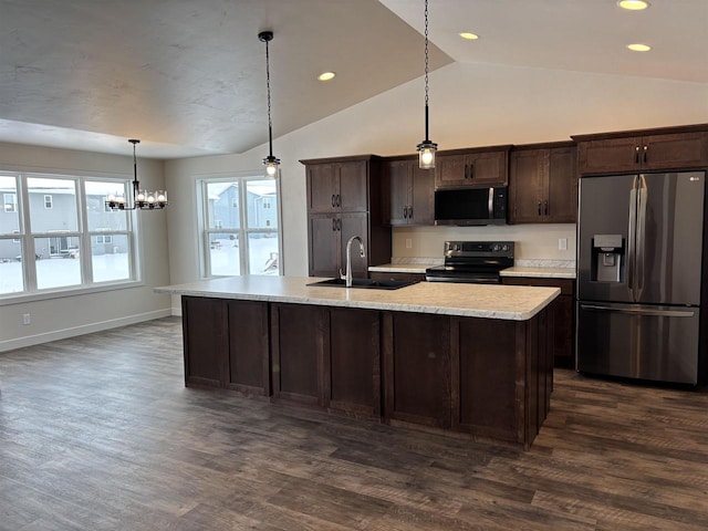 kitchen featuring sink, decorative light fixtures, dark brown cabinets, and appliances with stainless steel finishes