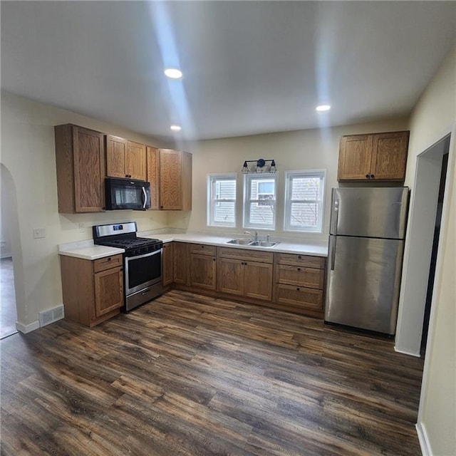 kitchen with dark hardwood / wood-style floors, sink, and appliances with stainless steel finishes