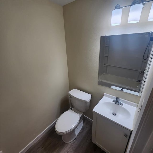 bathroom featuring hardwood / wood-style floors, vanity, and toilet