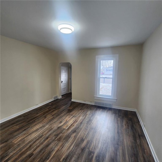 empty room with dark hardwood / wood-style floors