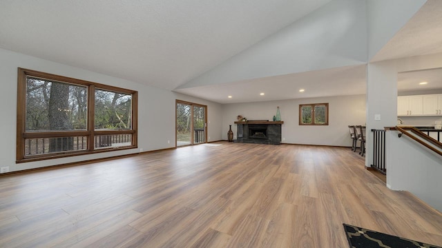 unfurnished living room featuring light hardwood / wood-style flooring and high vaulted ceiling