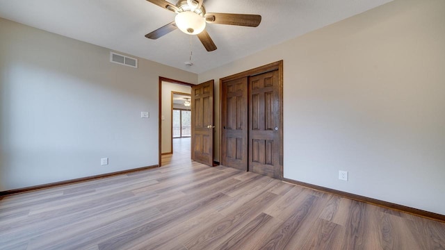 unfurnished bedroom with ceiling fan, light hardwood / wood-style floors, and a closet