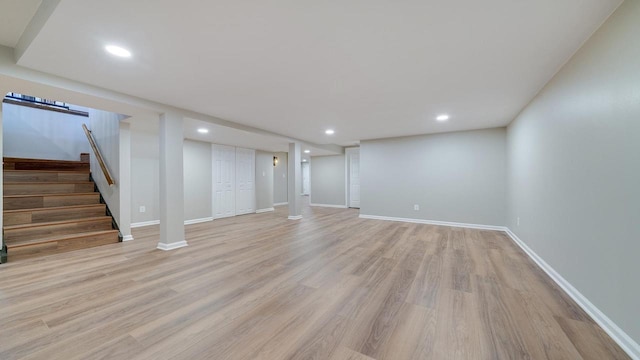 basement with light hardwood / wood-style flooring