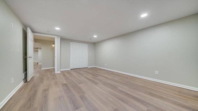 unfurnished bedroom with a closet and light hardwood / wood-style flooring