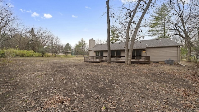 back of property with cooling unit and a wooden deck