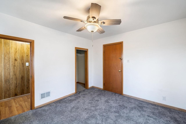 unfurnished bedroom with ceiling fan, a closet, and carpet floors