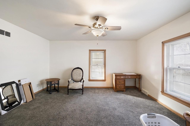 unfurnished room with ceiling fan, a healthy amount of sunlight, and dark colored carpet