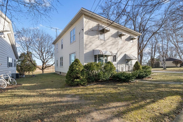 view of home's exterior featuring a yard and cooling unit