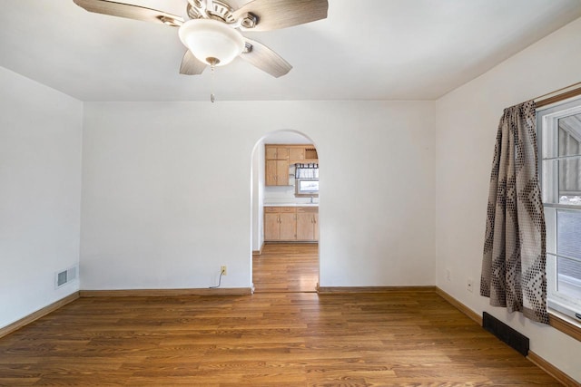 spare room featuring wood-type flooring and ceiling fan