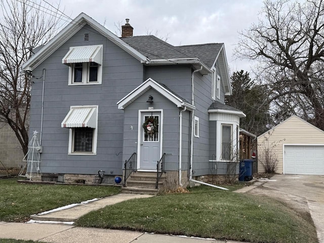 front of property featuring an outbuilding, a front lawn, and a garage