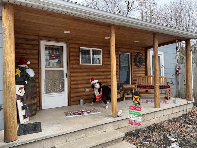 view of exterior entry with a porch