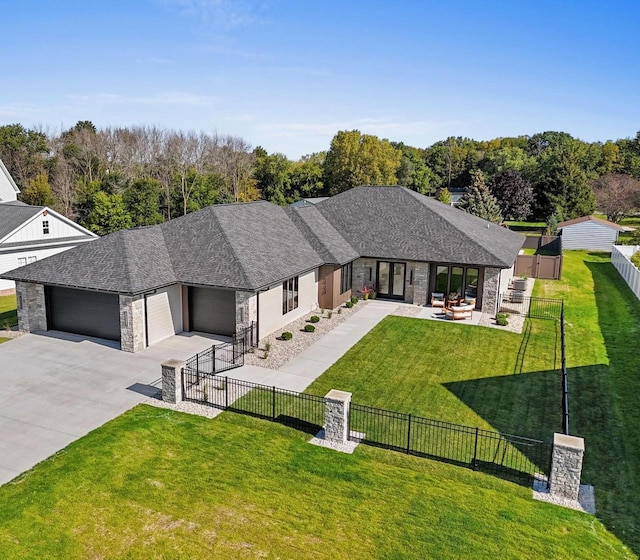 view of front facade with a garage, a patio, and a front yard