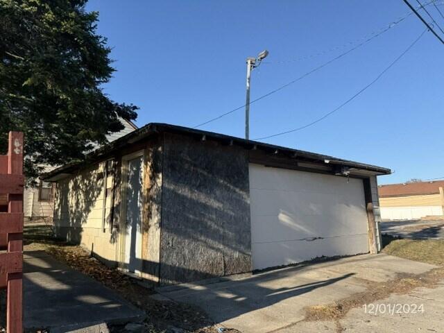 view of property exterior featuring an outdoor structure and a garage