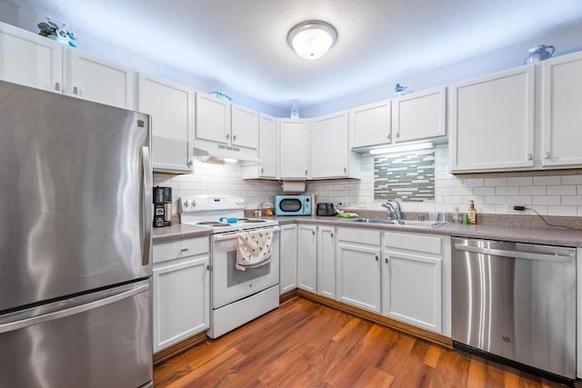 kitchen with white cabinetry, hardwood / wood-style floors, sink, and appliances with stainless steel finishes