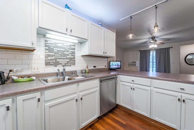 kitchen with kitchen peninsula, dark hardwood / wood-style flooring, white cabinets, sink, and dishwasher