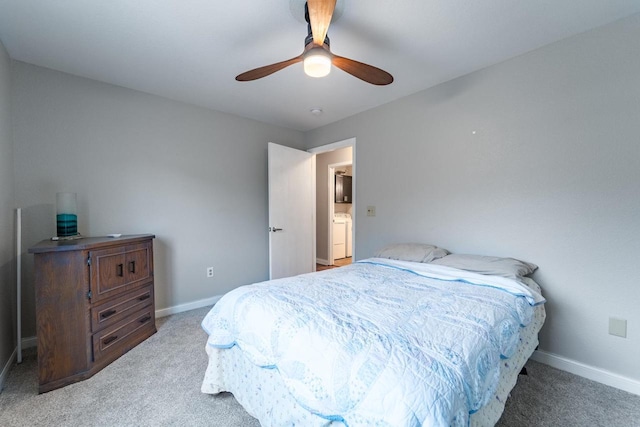 bedroom with carpet flooring, washer / dryer, and ceiling fan