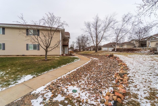 view of snow covered exterior with a yard