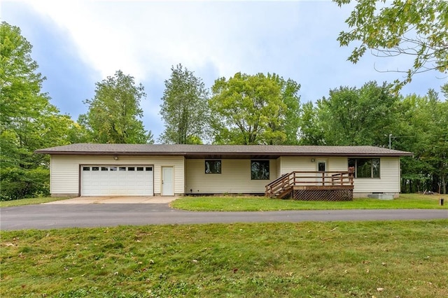 ranch-style home featuring a wooden deck, a front yard, and a garage