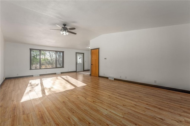 spare room featuring ceiling fan, light hardwood / wood-style floors, and vaulted ceiling