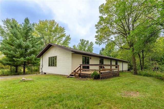 back of property with a lawn and a wooden deck