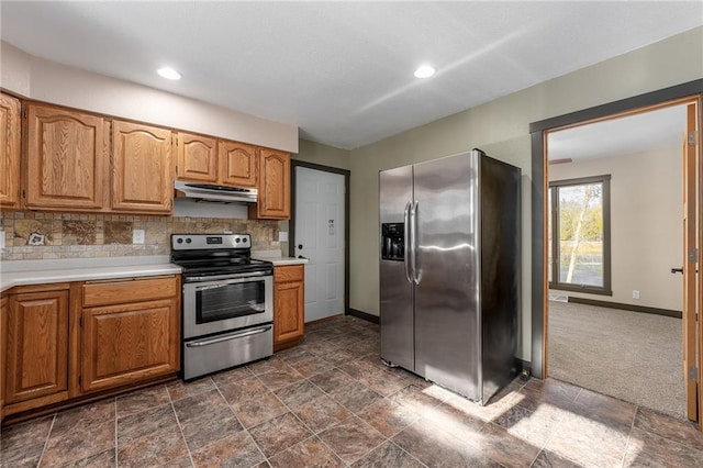 kitchen with backsplash, dark colored carpet, and appliances with stainless steel finishes