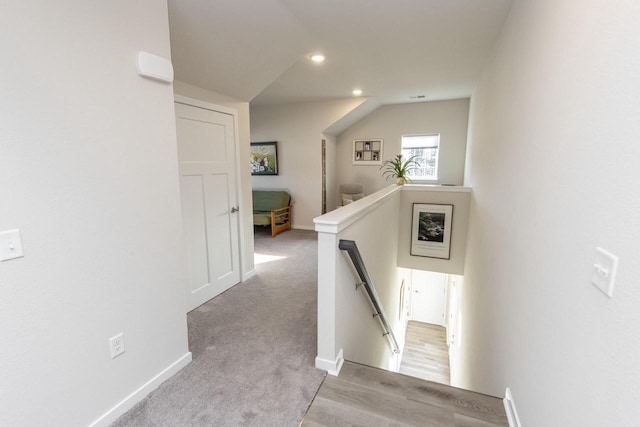 hall with light colored carpet