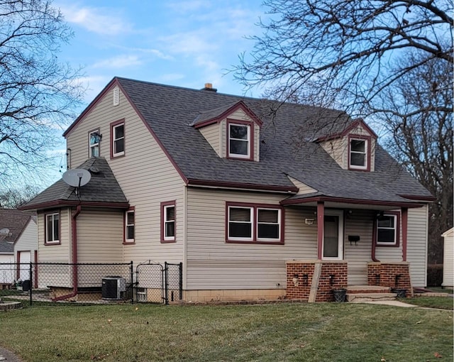 cape cod house with central AC and a front lawn