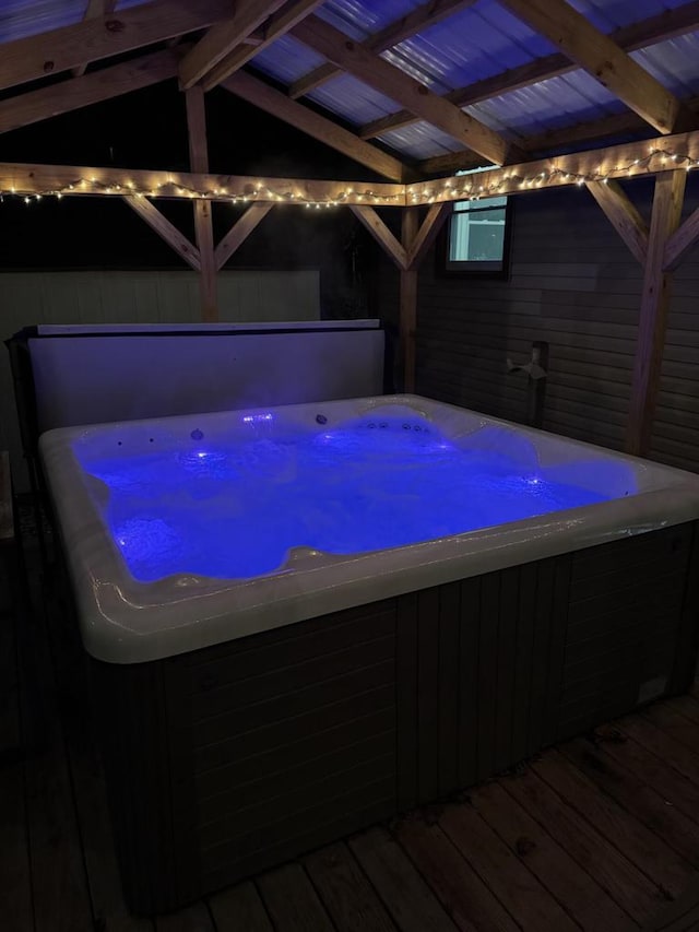 view of swimming pool featuring a wooden deck and a hot tub