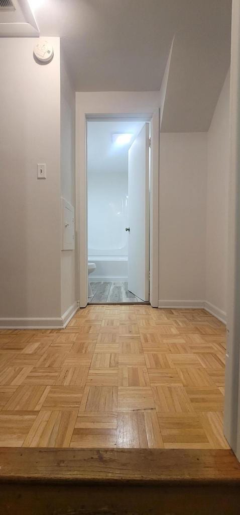 corridor featuring light parquet floors