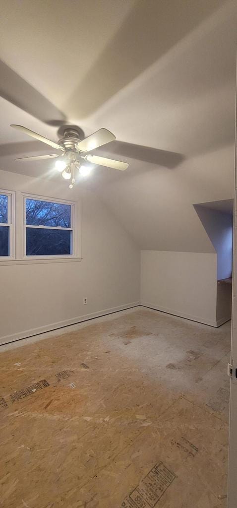 additional living space featuring vaulted ceiling and ceiling fan