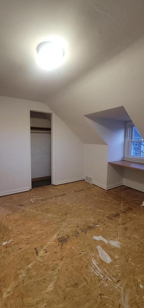 bonus room featuring lofted ceiling