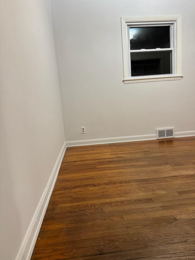 spare room featuring dark hardwood / wood-style floors