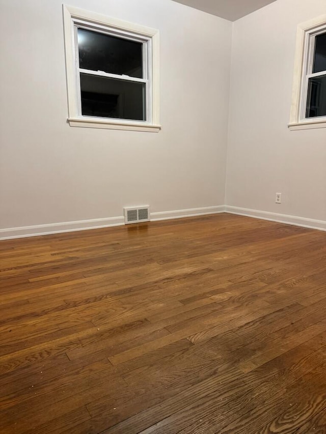 spare room featuring dark wood-type flooring