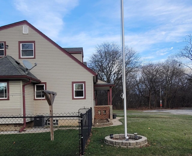 view of home's exterior with a yard and cooling unit