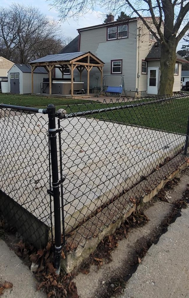 rear view of property with a gazebo and a lawn