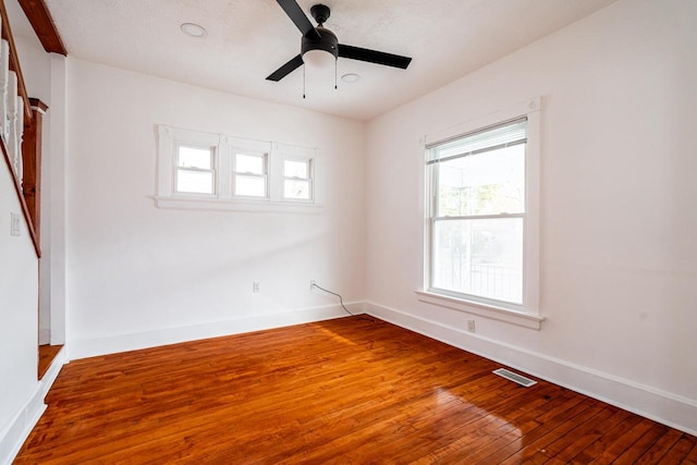 unfurnished room featuring ceiling fan, hardwood / wood-style floors, and a textured ceiling