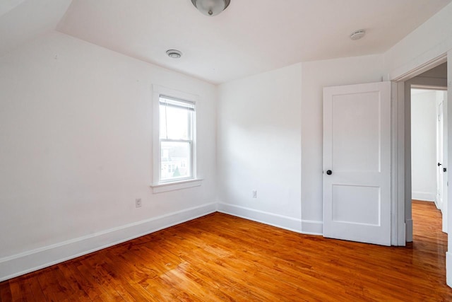 spare room featuring wood-type flooring