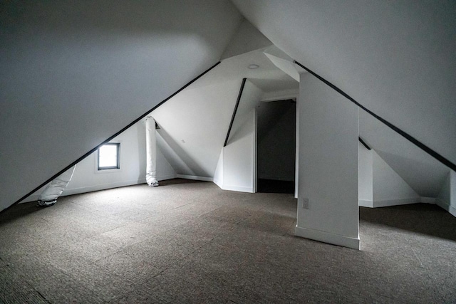 additional living space with carpet floors and vaulted ceiling