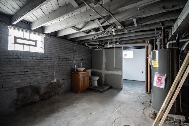 basement with gas water heater and sink