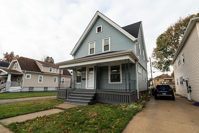 view of front of home featuring covered porch and a front yard