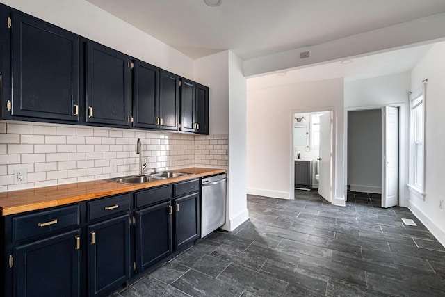 kitchen featuring stainless steel dishwasher, decorative backsplash, sink, and wooden counters