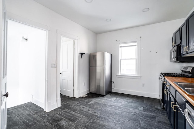 kitchen featuring wooden counters and stainless steel appliances