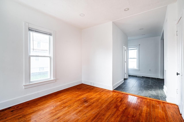 unfurnished room with dark hardwood / wood-style floors