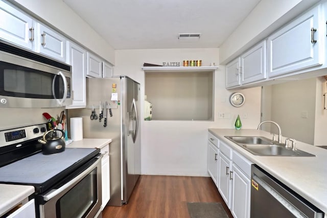 kitchen featuring white cabinets, sink, appliances with stainless steel finishes, and dark wood-type flooring