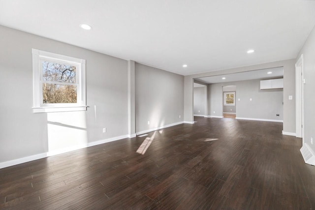 unfurnished living room featuring dark hardwood / wood-style flooring