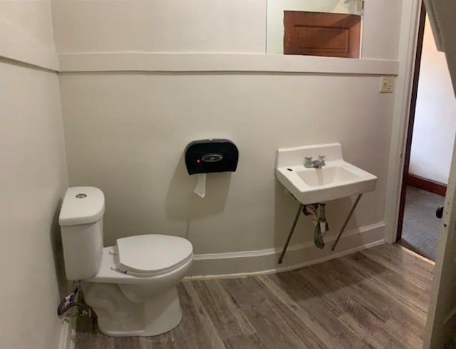 bathroom featuring sink, hardwood / wood-style floors, and toilet