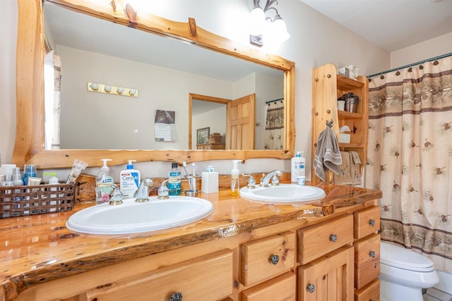 bathroom with vanity, toilet, and curtained shower