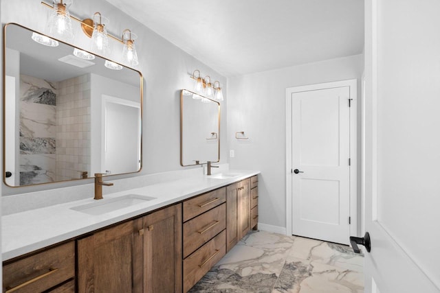 bathroom featuring tiled shower and vanity