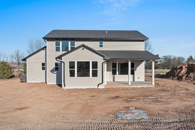 rear view of house with cooling unit and a patio